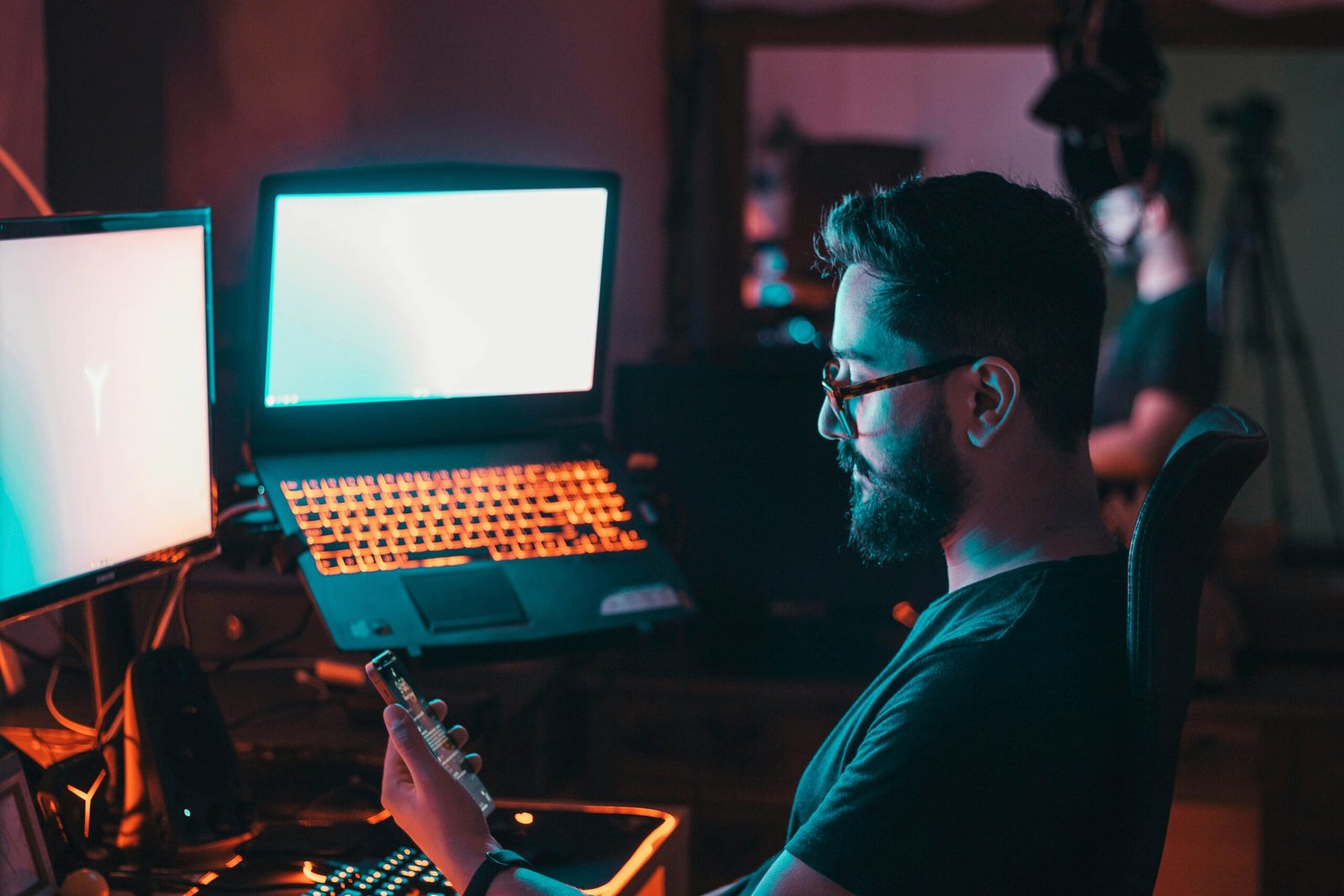 Person gaming in front of screens
