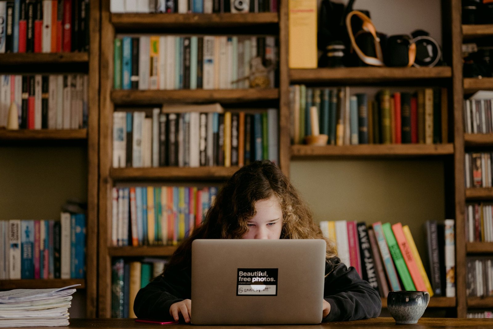 Student with a laptop open in a library